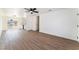 Open-concept room with modern flooring, ceiling fan, and direct access to the backyard through sliding doors at 1648 J St, Las Vegas, NV 89106