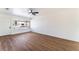 Bright living room featuring wood-look flooring, a modern ceiling fan, and a large window at 1648 J St, Las Vegas, NV 89106