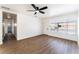 Open living area with wood floors, new ceiling fan, and access to the bathroom and hallway at 1648 J St, Las Vegas, NV 89106
