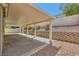 Covered patio perfect for outdoor seating, with stone accents and mature landscaping at 1751 Juniper Twig Ave, Las Vegas, NV 89183
