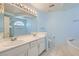 Bathroom featuring double sinks, a large mirror, and a soaking tub, perfect for relaxation at 1751 Juniper Twig Ave, Las Vegas, NV 89183