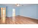 Bright bedroom with wood floors and multiple doorways to a bathroom and other rooms at 1751 Juniper Twig Ave, Las Vegas, NV 89183
