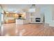 Open-concept space with hardwood floors, fireplace, and adjacent kitchen, perfect for entertaining at 1751 Juniper Twig Ave, Las Vegas, NV 89183