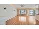 Bright and open living area features hardwood floors and large windows with access to the patio at 1751 Juniper Twig Ave, Las Vegas, NV 89183