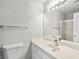 Full view of a pristine bathroom with a toilet, vanity, and shower featuring a glass door at 1800 Edmond St # 226, Las Vegas, NV 89146