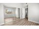 Bedroom with mirrored closet doors and wood-look flooring; open door leads to a bathroom at 1800 Edmond St # 226, Las Vegas, NV 89146