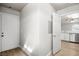 Hallway view leading into a kitchen with white cabinets and stainless steel appliances at 1800 Edmond St # 226, Las Vegas, NV 89146