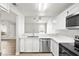 Stylish kitchen with modern appliances, a cozy breakfast bar, and an open view to the living area at 1800 Edmond St # 226, Las Vegas, NV 89146