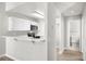 Modern kitchen features white cabinets and a sleek breakfast bar, leading to a cozy bathroom at 1800 Edmond St # 226, Las Vegas, NV 89146