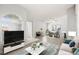 Open-concept living space with large windows, stylish furniture, and a seamless flow to the dining area at 1800 Edmond St # 226, Las Vegas, NV 89146