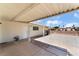 View of covered patio, white door, and low maintenance gravel yard at 1905 Aquarius Dr, Las Vegas, NV 89102