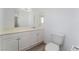 Bright bathroom with dual mirrors, white cabinetry and modern toilet at 1905 Aquarius Dr, Las Vegas, NV 89102