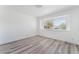Bright bedroom with large window, neutral walls and wood-look flooring at 1905 Aquarius Dr, Las Vegas, NV 89102