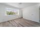 Bedroom featuring wood-look flooring and bright light from large window at 1905 Aquarius Dr, Las Vegas, NV 89102