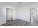 Bedroom featuring closet with sliding doors and wood-look floors at 1905 Aquarius Dr, Las Vegas, NV 89102