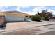 Single-story home featuring a two-car garage, low maintenance landscaping, and a neutral color palette at 1905 Aquarius Dr, Las Vegas, NV 89102