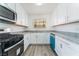 Updated kitchen featuring granite countertops, white cabinets, stainless steel appliances, and new flooring at 1905 Aquarius Dr, Las Vegas, NV 89102