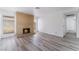 Inviting living room with cozy brick fireplace, updated flooring, and access to hallway at 1905 Aquarius Dr, Las Vegas, NV 89102