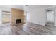 Inviting living room with cozy brick fireplace, updated flooring, and access to hallway at 1905 Aquarius Dr, Las Vegas, NV 89102