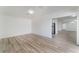 Spacious living room with durable wood-look flooring and neutral walls at 1905 Aquarius Dr, Las Vegas, NV 89102