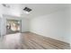 Bright room with sliding door access to the backyard and wood-look flooring at 1905 Aquarius Dr, Las Vegas, NV 89102