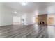 Bright living room with wood-look floors, brick fireplace, and abundant natural light with easy flow to kitchen at 1905 Aquarius Dr, Las Vegas, NV 89102
