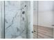 Modern bathroom featuring a frameless glass shower door and stylish marble-look tile surround at 1905 Aquarius Dr, Las Vegas, NV 89102