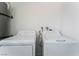 Close-up on the white washer and dryer appliances inside the property's laundry room at 1905 Aquarius Dr, Las Vegas, NV 89102