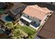 Aerial view of backyard with manicured lawn, outdoor seating area, covered patio, and lush landscaping at 191 Reed Ln, Henderson, NV 89074