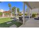 Inviting backyard featuring green lawn, patio, mature landscaping, and comfortable lounge furniture perfect for outdoor living at 191 Reed Ln, Henderson, NV 89074