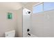 Clean, modern bathroom shower featuring tiled walls and a window, offering a refreshing and bright bathing space at 191 Reed Ln, Henderson, NV 89074
