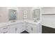 Bright bathroom featuring double vanities, quartz countertops, and stylish fixtures, complemented by hexagon tile flooring at 191 Reed Ln, Henderson, NV 89074
