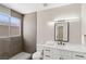 Modern bathroom with sleek fixtures, a large mirror, and stylish tiling at 191 Reed Ln, Henderson, NV 89074