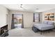 Spacious bedroom with a ceiling fan, a door to a balcony and a view of the neighborhood at 191 Reed Ln, Henderson, NV 89074