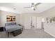 Bright bedroom with a large bed, a ceiling fan, a view of the en suite bathroom and stylish artwork at 191 Reed Ln, Henderson, NV 89074