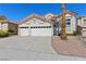 Charming home featuring a two-car garage, well-maintained landscaping, and welcoming curb appeal in a desirable neighborhood at 191 Reed Ln, Henderson, NV 89074