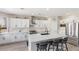 Bright kitchen with white cabinets, stainless steel appliances and an island with seating at 191 Reed Ln, Henderson, NV 89074