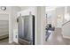 View of kitchen with stainless steel fridge and pantry, looking through to living area at 191 Reed Ln, Henderson, NV 89074