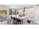 Modern kitchen features a large island with bar seating and sleek white cabinetry at 191 Reed Ln, Henderson, NV 89074