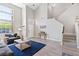Bright living room featuring high ceilings, a staircase, and modern interior design at 191 Reed Ln, Henderson, NV 89074