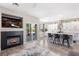 Stylish open-concept kitchen and living room area with a fireplace, backyard access, and modern kitchen island at 191 Reed Ln, Henderson, NV 89074