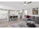 Open-concept living area featuring a spacious kitchen with stainless steel appliances and a comfortable gray sectional sofa at 191 Reed Ln, Henderson, NV 89074