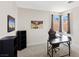 Bright room with a desk, chair, and shelving, enhanced by natural light from the windows at 191 Reed Ln, Henderson, NV 89074