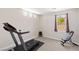 Bright room featuring a treadmill and neutral carpeting, perfect for home fitness and exercise at 191 Reed Ln, Henderson, NV 89074