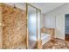 Bathroom featuring a separate shower and tub with decorative tiles and a view of the walk-in closet at 1933 Coralino Dr, Henderson, NV 89074