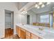 Bathroom with a wide double sink vanity, granite countertop, tile floors, separate shower, and arched doorways at 1933 Coralino Dr, Henderson, NV 89074