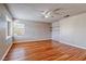 Light-filled bedroom with wood floors, ceiling fan, and closet with shelving at 1933 Coralino Dr, Henderson, NV 89074
