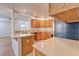 Well-lit kitchen featuring light wood cabinetry, modern appliances, and an open layout leading to living area at 1933 Coralino Dr, Henderson, NV 89074