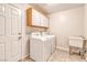 Functional laundry room with washer, dryer, and ample storage at 1933 Coralino Dr, Henderson, NV 89074