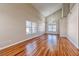 Bright and spacious living room featuring hardwood flooring, large windows, and vaulted ceilings at 1933 Coralino Dr, Henderson, NV 89074